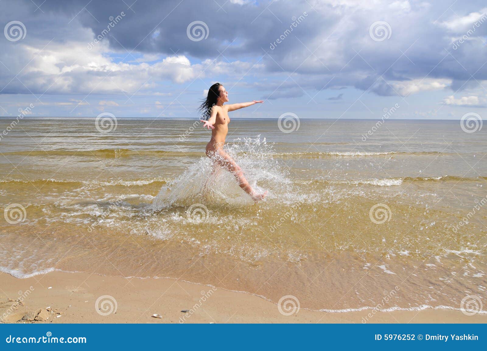 Nude girl running on beach